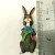 BUNNY FIGURINES SET ONE HAS FLOWERS IN HAND