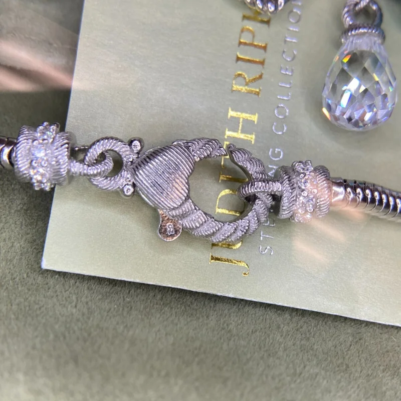 Judith Ripka Silver 925 CZ Charms Bracelet Size 7.5” Long, 7 pieces, Pouch, Box