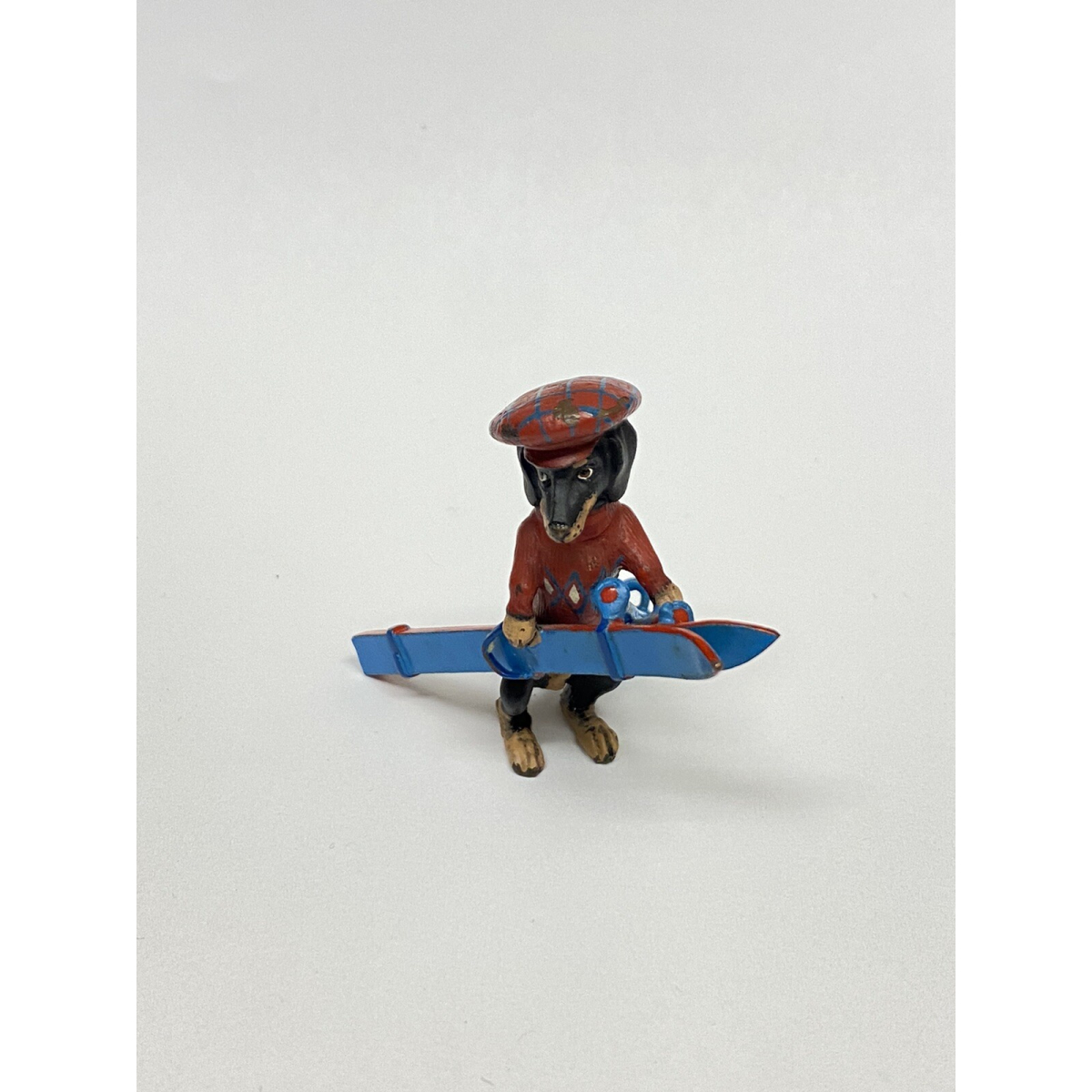 1 3/4 LONG DOGGY WITH RED HAT , RED SWEATER WITH BLUE SKI DECOR FOR TABLE