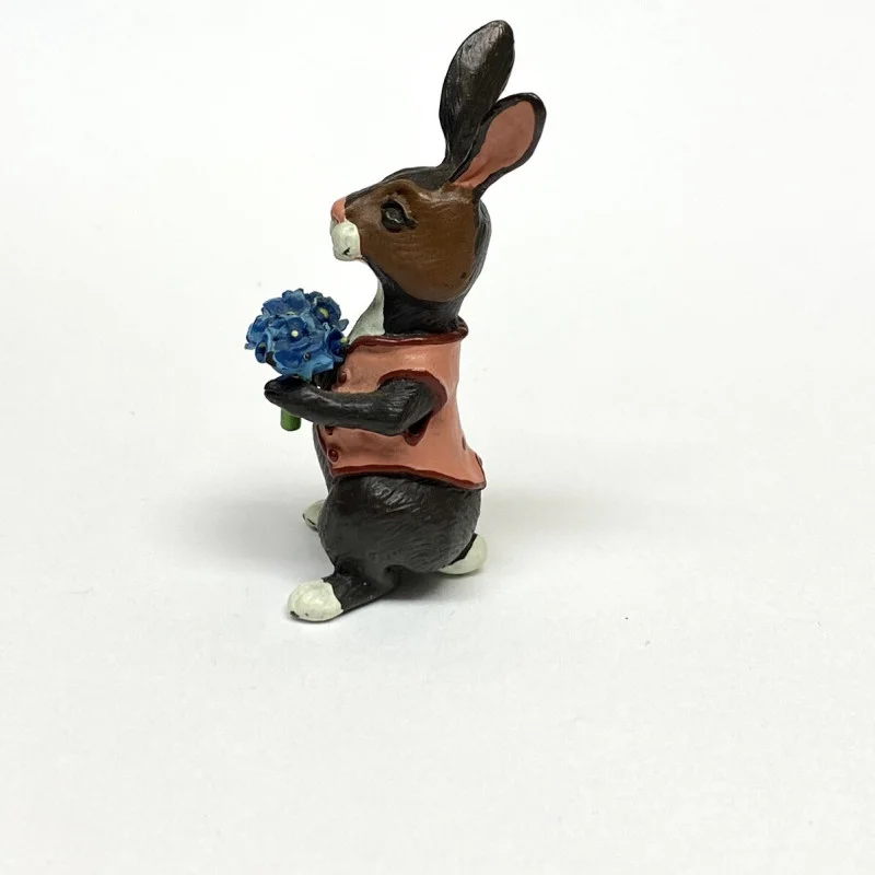 BUNNY FIGURINES SET ONE HAS FLOWERS IN HAND