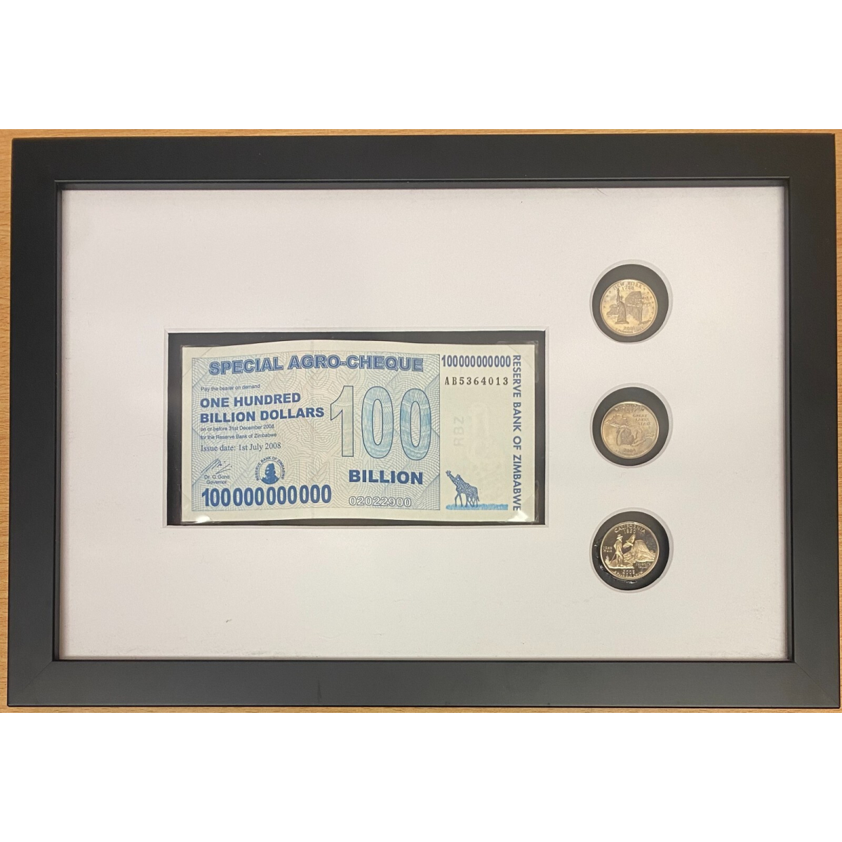 Framed Zimbabwe 100 Billion dollar Agro Cheque banknote and American Coins